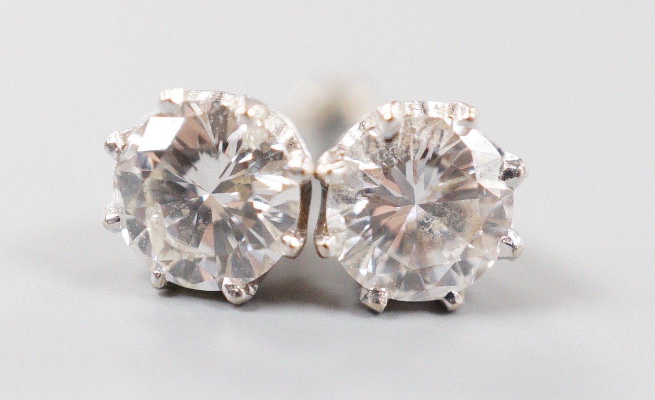 A modern pair of 18k white metal and solitaire diamond set ear studs (butterflies differ), gross weight 1.4 grams